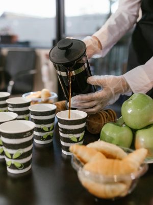 Person Pouring Coffee on White Ceramic Cup